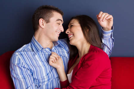Loving couple hugging and talking at home.