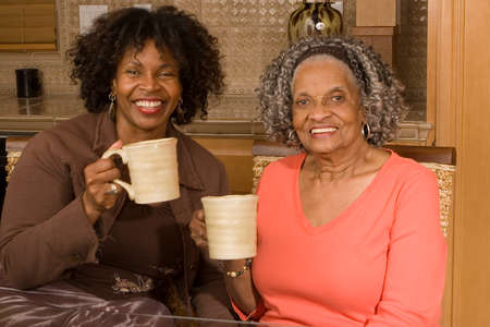 Senior woman having coffee with her daughter.の写真素材
