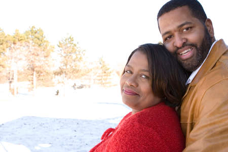 Mature African American couple laughing and hugging.の写真素材