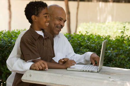 African American grandfather and grandson working on the computer.の写真素材