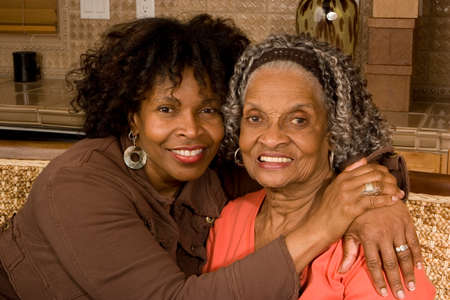Portrait of a senior woman hugging her daughter.の写真素材