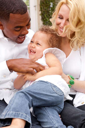Portrait of happy multicultural family smiling.の写真素材
