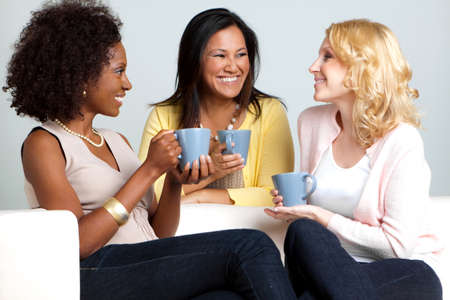 Diverse group of women talking and drinking coffee.の写真素材