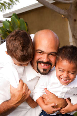 Father carrying son laughing and smiling.