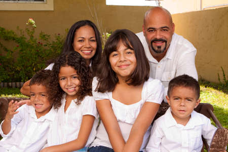 Happy Hispanic family laughing and smiling.の写真素材