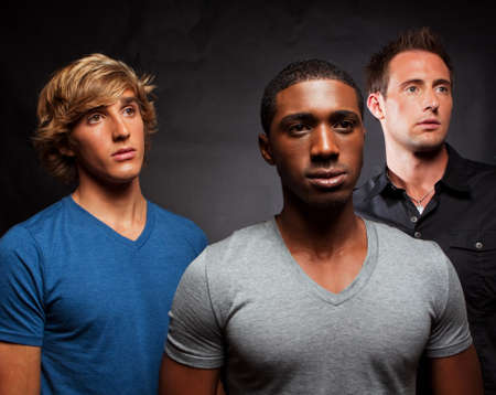 Diverse group of men isolated on grey.の写真素材