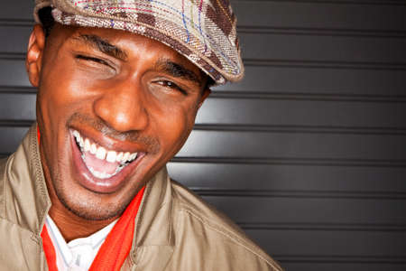 Happy fashionable young man laughing.の写真素材