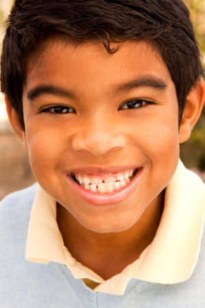 Cute young boy laughing and smiling.