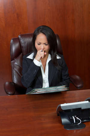 Asian American businesswoman tired at work.の写真素材