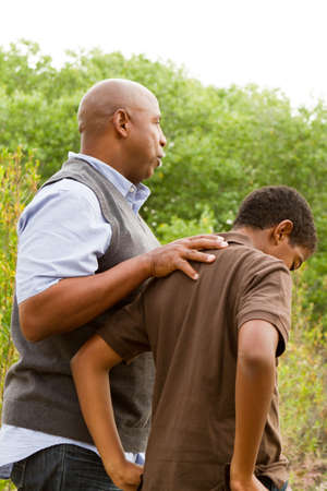 Father comforting his son.の写真素材