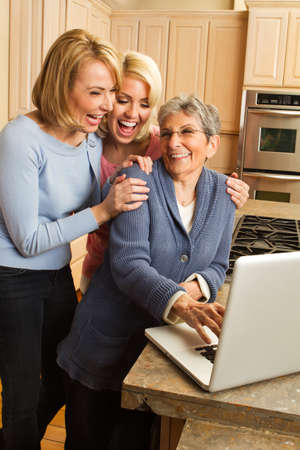 Granddaughter helping her grandmother on the computer.の写真素材