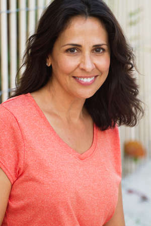 Beautiful hispanic woman smiling at the beach.の写真素材