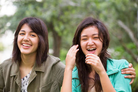 Asian mother laughing and huging her children.の写真素材