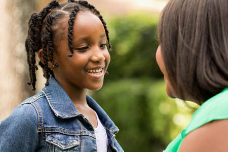 Happy African American mother and daughter.