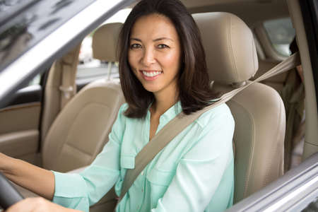 Happy woman driving and smiling.