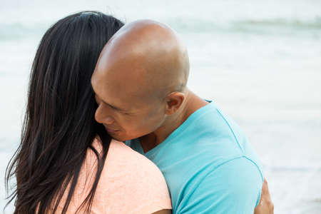 Couple on the beach smiling.の写真素材