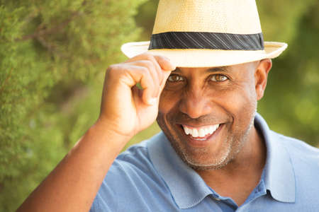 African American man tipping his hat outside.の写真素材