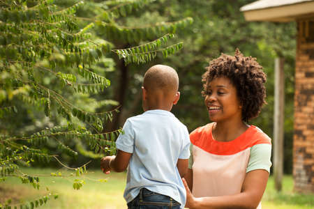 Young African American mother playing and her son.の写真素材