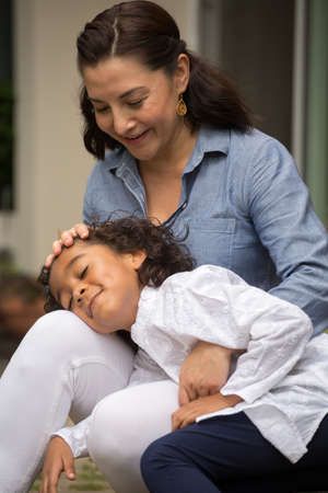 Hispanic mother and her daughter.の写真素材