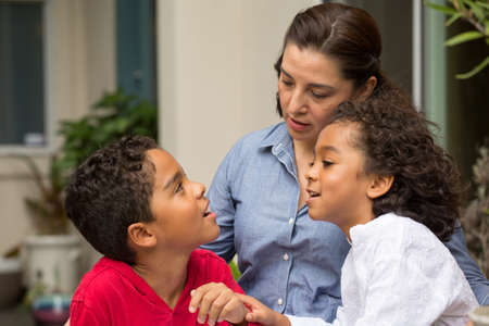 Hispanic mother talking with her childeren.の写真素材