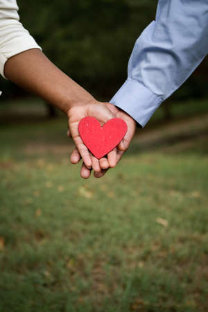 African American loving couple holding a heart.の写真素材