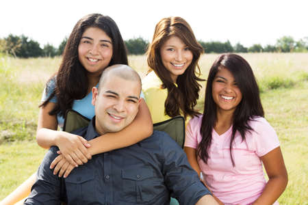 Hispanic father and his daughters.