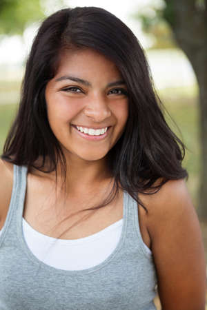 Young Hispanic girl smiling outside.の写真素材