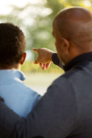 Father talking and spending time with his teenage son.の写真素材