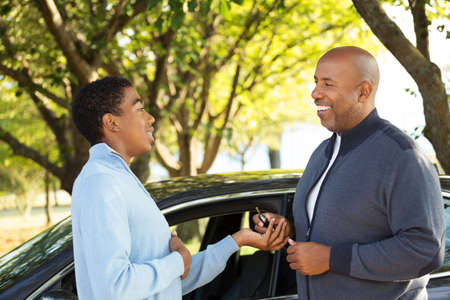 Father teaching his son how to drive.