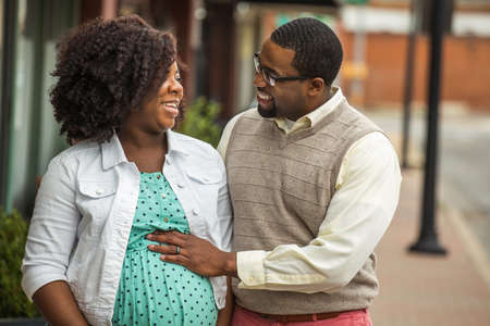 Portrait of a happy pregnant African American couple.の写真素材