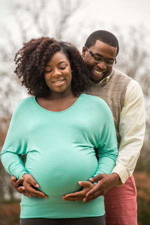 Portrait of a happy pregnant African American couple.の写真素材