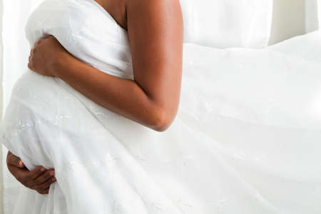 Close up of a pregnant woman's stomach.の写真素材