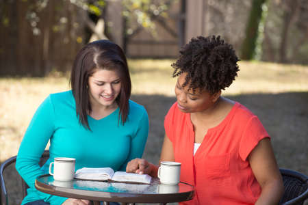 Friends reading, praying and learning together.の写真素材