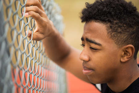 Young teenage boy in deep thought.の写真素材