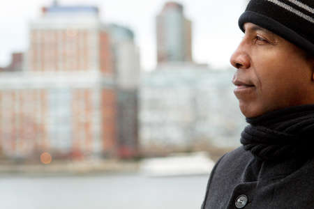 Man outside wearing a hat and coat.