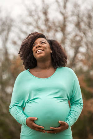 Portrait of a happy pregnant African American couple.の写真素材