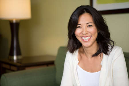 Portrait of an Asian woman smiling.