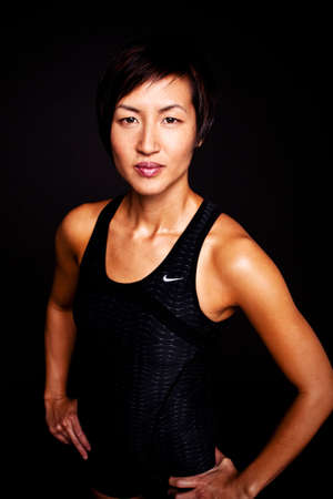 Fit Asian woman isolated on black.の写真素材