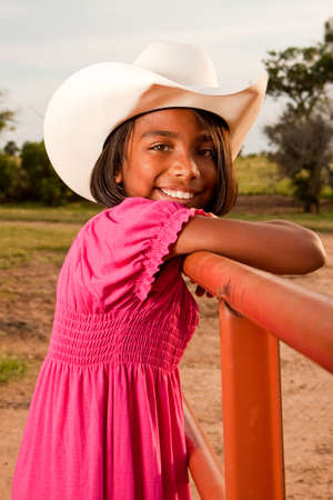 Hispanic little girl wearing a hat with an American flag.の写真素材