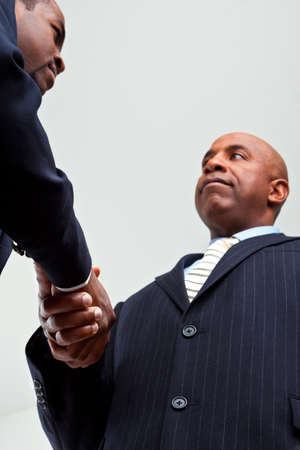 African American businessmen shaking hand isolated on white.の写真素材