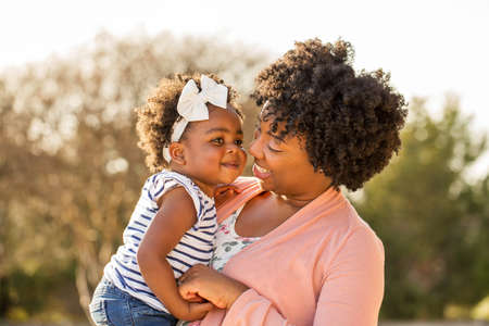 African American mother holding her daughter.の写真素材