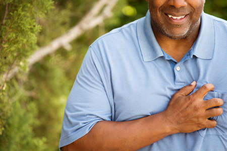 African American man having heart pains.の写真素材