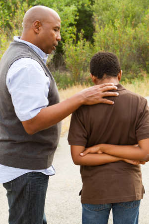 Father comforting his son.の写真素材
