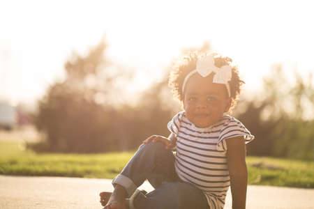 Happy little girl laughing and smiling outside.