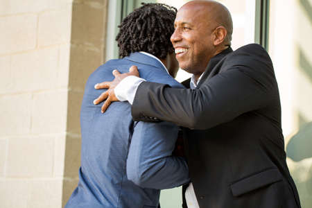 Mature African American casually dressed businessman shaking hands.