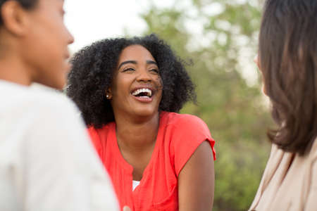Multi-ethnic group of women laughing and talking.の写真素材