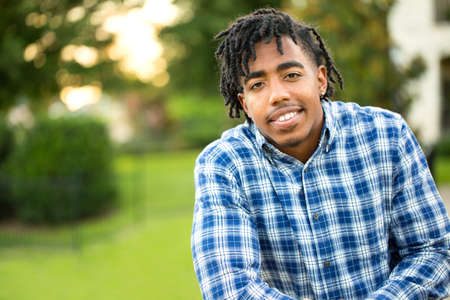 Young handsome African American man smiling outside.の写真素材