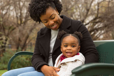 Happy African American mother and her daugher.