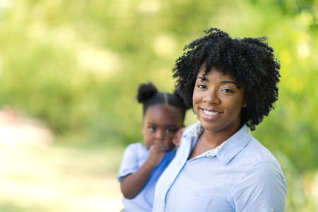 Portrait of an African American mother holding her little girl.の写真素材