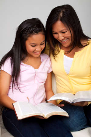 Asian mother and daughter reading and studying.